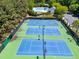 Aerial view of tennis and basketball courts with a pool area visible in the distance, promoting an active lifestyle at 1241 Dalgarven Dr, Apex, NC 27502