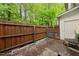 Private backyard features a wood fence, mature trees, and a patio area at 126 Star Thistle Ln, Cary, NC 27513