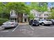 Exterior view of townhomes with designated parking and tree-lined landscaping in a well-maintained community at 126 Star Thistle Ln, Cary, NC 27513