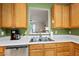 Bright kitchen featuring oak cabinetry, stainless steel appliances, and an open layout at 126 Star Thistle Ln, Cary, NC 27513