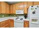 Traditional kitchen with light oak cabinets, white countertops, and modern appliances at 126 Star Thistle Ln, Cary, NC 27513