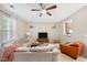 Cozy living room featuring a ceiling fan, plush sofa, and modern entertainment center at 126 Star Thistle Ln, Cary, NC 27513