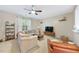 Comfortable living room with a large window, ceiling fan, and a relaxing seating area at 126 Star Thistle Ln, Cary, NC 27513