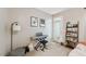 Bright living room featuring a keyboard, shelving, and a door offering outdoor access at 126 Star Thistle Ln, Cary, NC 27513