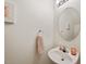 Cozy powder room with a sleek sink, round mirror, and tasteful decor at 126 Star Thistle Ln, Cary, NC 27513