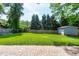 Spacious, fenced in backyard with a large grassy area and a brick patio at 1321 Bloomingdale Dr, Cary, NC 27511