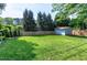 This home features a large fenced in backyard, lush greenery and a storage shed at 1321 Bloomingdale Dr, Cary, NC 27511