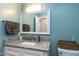 Bathroom features a granite countertop, a white vanity, and a framed mirror at 1321 Bloomingdale Dr, Cary, NC 27511