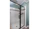 Bathroom featuring a glass shower door, white subway tiles, and a shower head at 1321 Bloomingdale Dr, Cary, NC 27511
