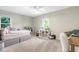 A large bedroom with carpet, natural light from two windows, and decorated with fun colors at 1321 Bloomingdale Dr, Cary, NC 27511