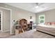 Cozy bedroom featuring a dollhouse, ceiling fan and bright, sun-filled windows at 1321 Bloomingdale Dr, Cary, NC 27511