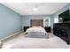 The bedroom offers neutral paint, carpet, a ceiling fan and furniture at 1321 Bloomingdale Dr, Cary, NC 27511