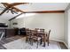 View of dining room with wood beams, rug, and direct access to the living room for easy entertaining at 1321 Bloomingdale Dr, Cary, NC 27511