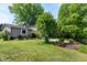 Charming single-Gathering home features lush landscaping, mature trees, and a well-manicured lawn at 1321 Bloomingdale Dr, Cary, NC 27511