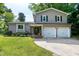 Charming two-story home featuring neutral siding, black shutters, a two-car garage, and well-maintained landscaping at 1321 Bloomingdale Dr, Cary, NC 27511
