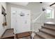 Foyer with a white front door, stairway with carpeting, and modern flooring at 1321 Bloomingdale Dr, Cary, NC 27511