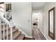 Hallway showcasing hardwood floors, stairway, and access to a room with carpet at 1321 Bloomingdale Dr, Cary, NC 27511