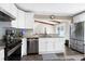 Open kitchen with stainless steel appliances, granite countertops, and access to the dining area at 1321 Bloomingdale Dr, Cary, NC 27511