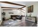 Spacious living room with hardwood floors, wood beams, and comfortable seating area at 1321 Bloomingdale Dr, Cary, NC 27511