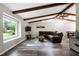 Inviting living room with a large window, wood beams, hardwood floors, and comfortable seating at 1321 Bloomingdale Dr, Cary, NC 27511