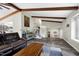 Open-concept living room with hardwood floors, wood beams, and comfortable seating at 1321 Bloomingdale Dr, Cary, NC 27511