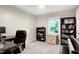 Comfortable home office featuring a large desk, bookshelves, and a bright window at 1321 Bloomingdale Dr, Cary, NC 27511