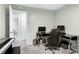 Home office with dual monitors, electric piano, and organized shelving for a productive space at 1321 Bloomingdale Dr, Cary, NC 27511