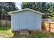 A backyard storage shed with latticework foundation and stained wood access ramp at 1321 Bloomingdale Dr, Cary, NC 27511