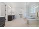 Modern bathroom showcasing a glass-enclosed shower, soaking tub, and double vanity at 1400 Hedgelawn, Raleigh, NC 27615
