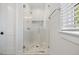 Shower with a glass door and tile surround at 1400 Hedgelawn, Raleigh, NC 27615