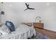 Well-lit bedroom boasting hardwood floors, a ceiling fan, and elegant furniture at 1400 Hedgelawn, Raleigh, NC 27615