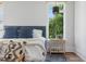 Bright bedroom featuring a large window and stylish decor, creating a cozy atmosphere at 1400 Hedgelawn, Raleigh, NC 27615