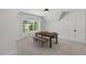 Bright bonus room featuring a wooden table and bench with natural light from a large window at 1400 Hedgelawn, Raleigh, NC 27615