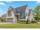 Beautiful two-story home with a gray roof, gray garage door, and nicely manicured front lawn at 1400 Hedgelawn, Raleigh, NC 27615
