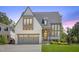 Beautiful two-story home with a gray roof, gray garage door, and nicely manicured front lawn at 1400 Hedgelawn, Raleigh, NC 27615