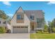 Charming two-story home with gray garage door and well-manicured lawn at 1400 Hedgelawn, Raleigh, NC 27615