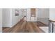 Hallway with hardwood floors leading to a built in decorative bookshelf at 1400 Hedgelawn, Raleigh, NC 27615