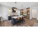 Bright, modern kitchen featuring a large island with seating, pendant lighting, and stainless steel appliances at 1400 Hedgelawn, Raleigh, NC 27615