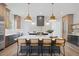 Spacious kitchen with a central island, pendant lights, custom cabinets, and modern appliances at 1400 Hedgelawn, Raleigh, NC 27615