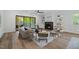 Comfortable living room with a fireplace, neutral tones, and access to the outdoors at 1400 Hedgelawn, Raleigh, NC 27615