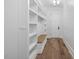 Mudroom featuring built-in bench with storage, wood floors, and white shiplap walls at 1400 Hedgelawn, Raleigh, NC 27615
