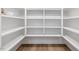 Organized walk-in pantry with custom shelving and hardwood floors at 1400 Hedgelawn, Raleigh, NC 27615