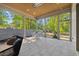 Inviting covered patio featuring stone floors and comfortable seating, perfect for outdoor relaxation at 1400 Hedgelawn, Raleigh, NC 27615