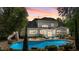 Backyard view features a large in-ground pool, patio, and lush landscaping at 14013 Wallberman Dr, Wake Forest, NC 27587