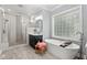 A spacious bathroom with a glass-enclosed shower, a soaking tub, and a vanity with elegant fixtures at 14013 Wallberman Dr, Wake Forest, NC 27587
