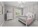 A cozy bedroom is decorated with a charming bed, dresser and an eye-catching light fixture at 14013 Wallberman Dr, Wake Forest, NC 27587