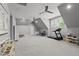 Spacious bonus room featuring carpet, ceiling fans, storage, exercise equipment, and a play area at 14013 Wallberman Dr, Wake Forest, NC 27587