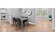 Dining area featuring hardwood flooring, round wall decorations, and windows with lots of natural light at 14013 Wallberman Dr, Wake Forest, NC 27587