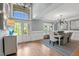 Airy entryway with hardwood floors, wainscoting, transom windows, and dining room access at 14013 Wallberman Dr, Wake Forest, NC 27587