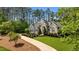 Landscaped front yard showcasing a luxury two-story home with a manicured lawn and elegant stone details at 14013 Wallberman Dr, Wake Forest, NC 27587